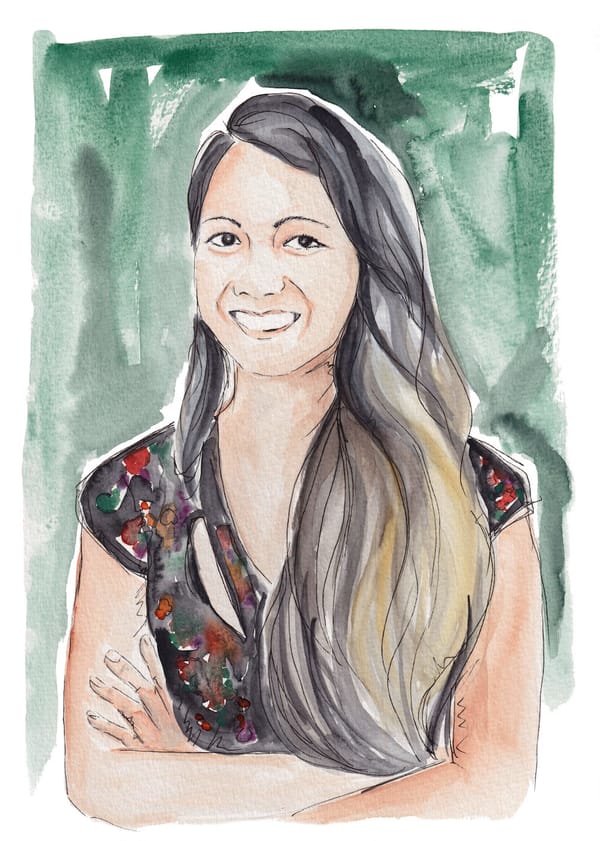 A watercolor showing Daniella Zalcman smiling in a short-sleeved top, with her long dark hair swept down one side of her face