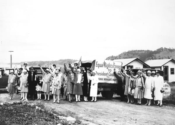 A group of pro-ERA demonstrators in 1927 hold their hands aloft.