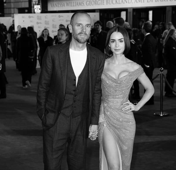 Black and white image of Lily Collins in a sparkly dress and her husband Charlie McDowell in a three-piece suit.