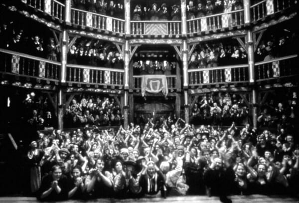 A black and white photograph of a rapturous audience in a packed theater.